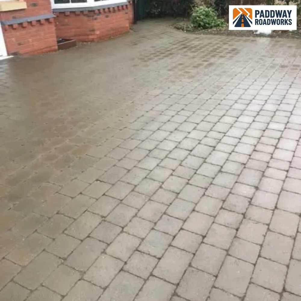 Freshly cleaned block paving driveway, wet after pressure washing