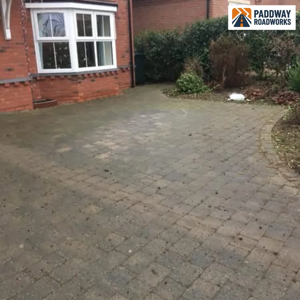 Block paved driveway with a red brick border completed at a bay window home