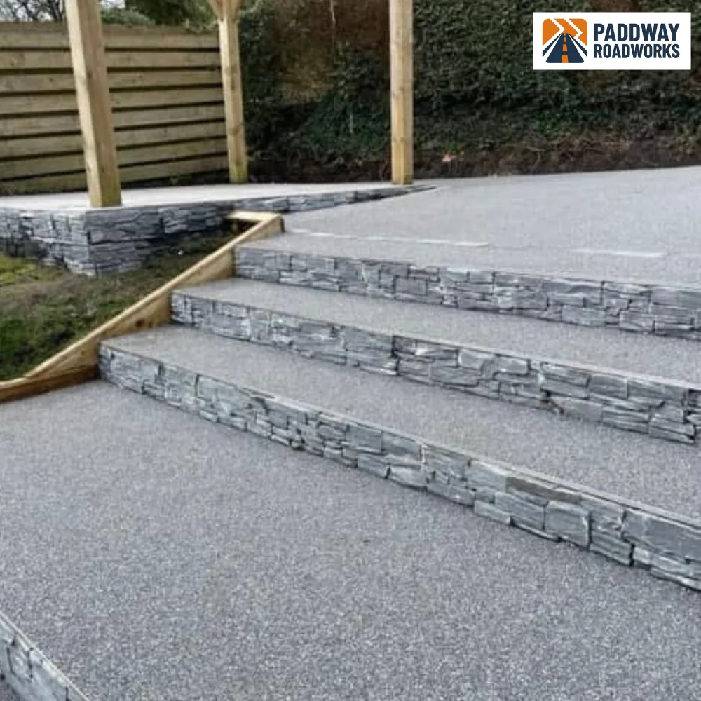 Resin bound steps finished with stacked natural stone risers