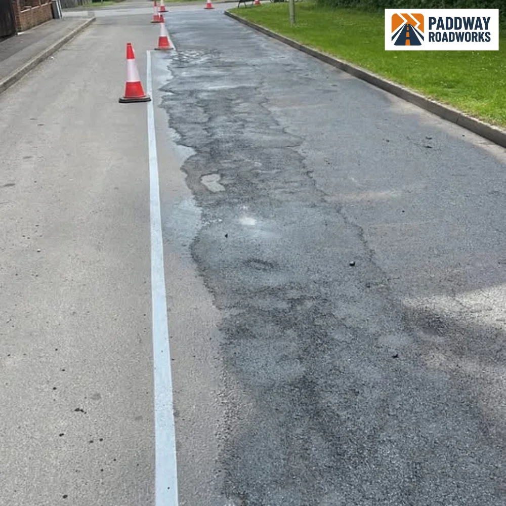 Fresh white lining set out on a newly slurry sealed surface