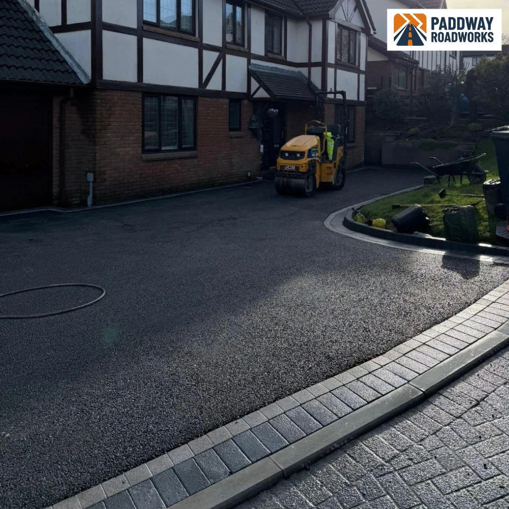 Newly laid tarmac driveway at a detached house, Paddway Surfacing Solutions tipper on site